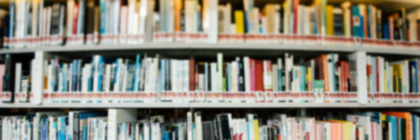 Shelf filled with books on design, creativity, and marketing, representing the knowledge and inspiration behind podcast advertising success.