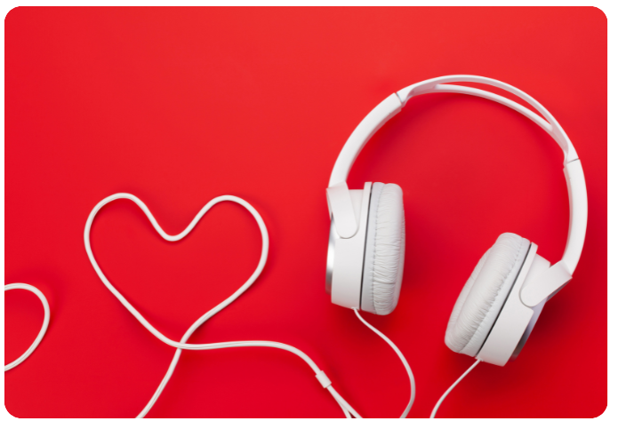 White wired headphones, with the wire shaped into a heart. Red background. The Podcast and YouTube Ads That Stuck with Us