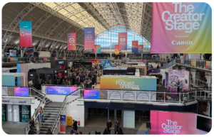 The main hall at The Podcast Show 2026 in London, with the Creator Stage and partner banners overhead