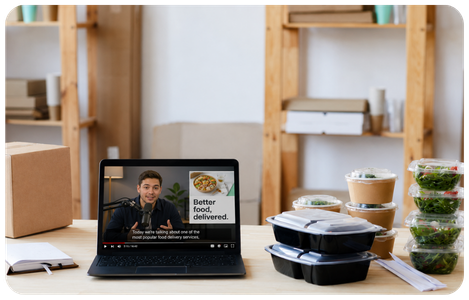 Podcast host delivering a host-read ad for a meal delivery brand, with meal prep containers on the desk