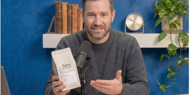 Podcast host making direct eye contact with the camera while holding up a coffee product during a YouTube ad read