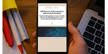 Smartphone displaying news about IAB legislation addressing AI use of publisher content, representing concerns about AI scraping and the future of ad supported media