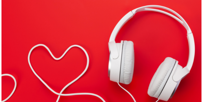 White wired headphones, with the wire shaped into a heart. Red background. The Podcast and YouTube Ads That Stuck with Us