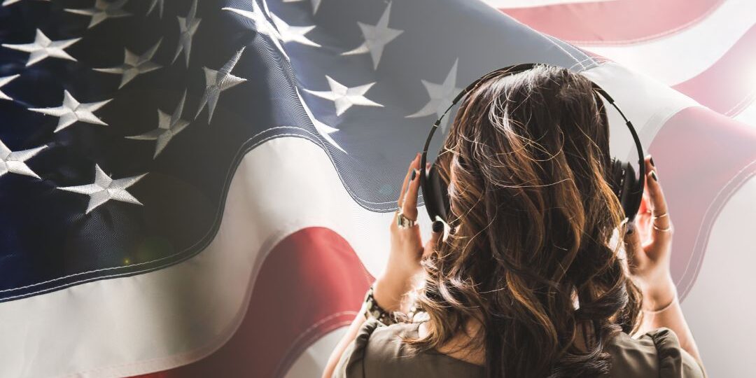 USA Flag in the background with a young women with shoulder length hair back on with headphones. 2024 Is the podcast election.