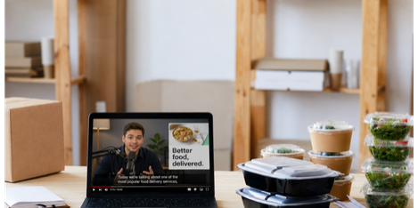 Podcast host delivering a host-read ad for a meal delivery brand, with meal prep containers on the desk