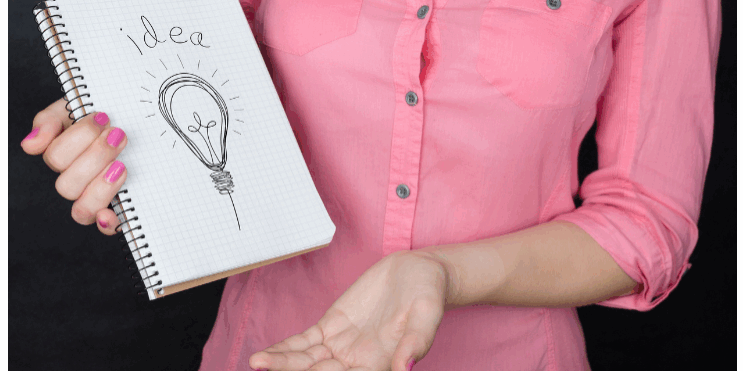 Woman in pink shirt holding spiral notebook with hand-drawn lightbulb labeled 'IDEA' - representing creative brainstorming for podcast sponsorship proposals